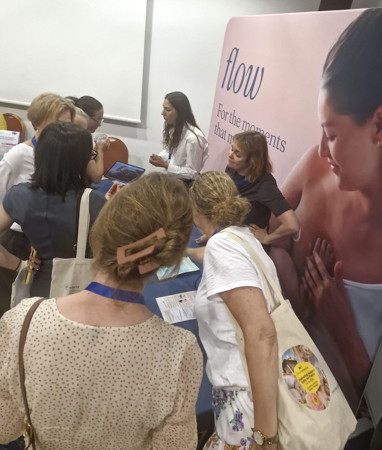 IBCLCs gathered around the Flow booth at ELACTA 2026