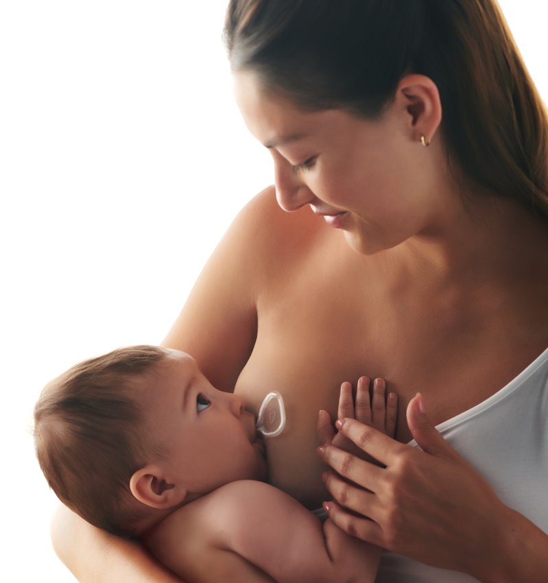 Mother breastfeeding baby with Flow nipple shield