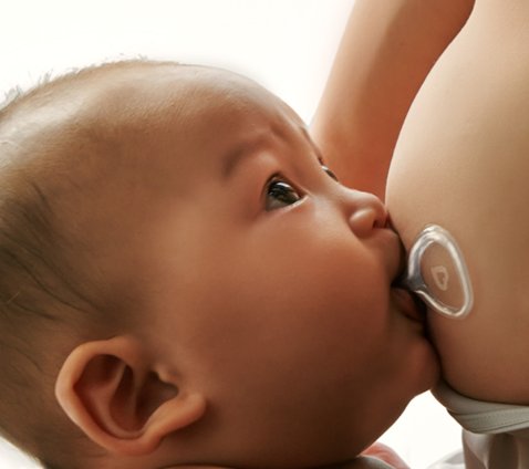 Baby breastfeeding with Flow shield in place